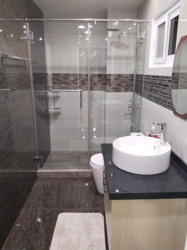 a bathroom with a shower and a sink and a toilet at Luxurious Penthouse La Grande Résidence with Home Theater & Netflix in Angeles