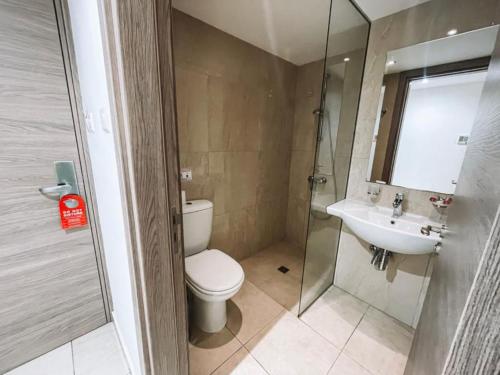 a bathroom with a toilet and a sink and a shower at Sunny Blue Hotel in Ayia Napa