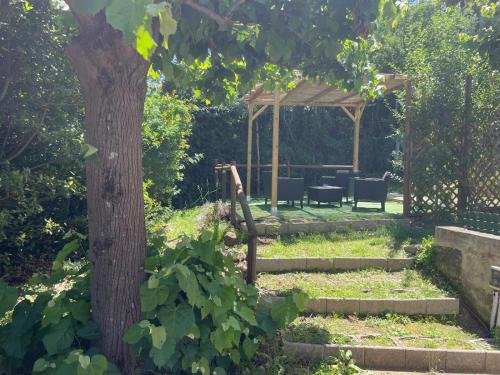 a garden with a gazebo and a tree at Villa del Monte di Cocco in Massarosa