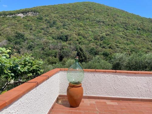a glass bottle sitting on the ledge of a balcony at Villa del Monte di Cocco in Massarosa
