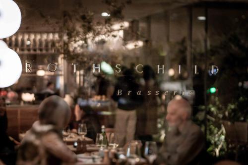 a couple of people sitting at a table in a restaurant at R48 Hotel and Garden in Tel Aviv