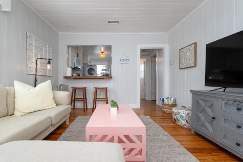 a living room with a couch and a table at Be A Nomad - Beach Bliss - Close to beach in Jacksonville Beach
