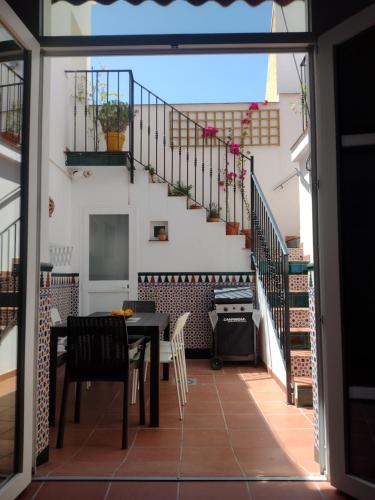 a dining room with a table and a staircase at Casa Valparaíso Málaga for everybody in Málaga
