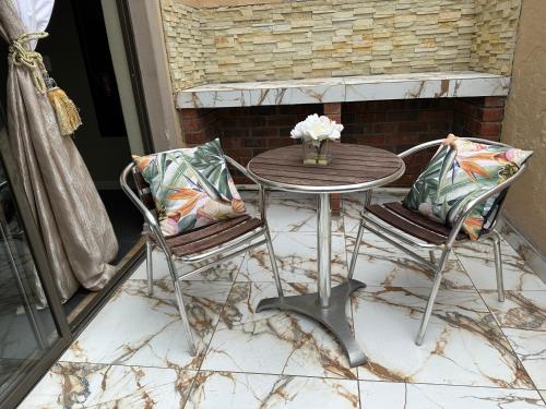 a table and two chairs on a patio at Repa Boutique Lodge Self-Catering Units in Kimberley