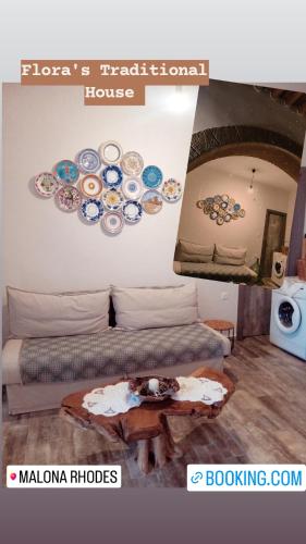 a room with two beds and a table with plates on the wall at Flora's Traditional House in Malona Village