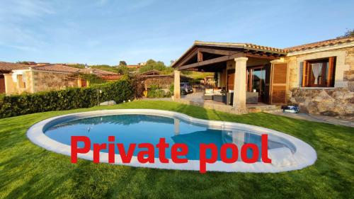 a pool in a yard with the words private pool at Villa Janas con piscina privata Budoni in Tanaunella
