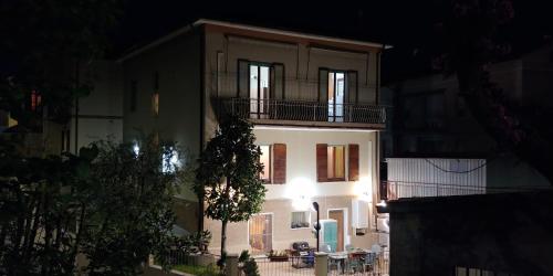 a white building with a balcony on top of it at B&B Itala in Recanati