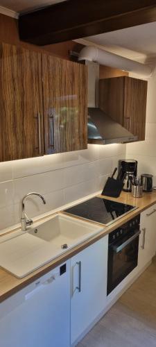 a kitchen with a sink and a stove at Drachenburg in Marktbreit