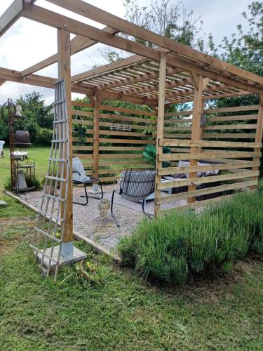 a wooden pergola with a bench and a ladder at The Studio, in Saint-Rabier