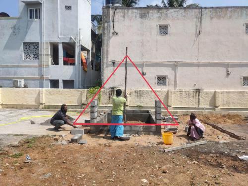 a group of people working on a construction site at Starlit premium camps in Mahabalipuram