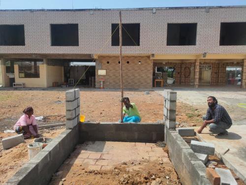 a group of people sitting in front of a building at Starlit premium camps in Mahabalipuram
