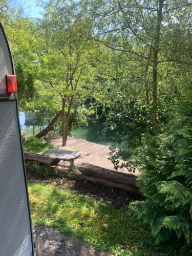 a picnic table and a bench in a park at Casa Herban 2 in Moara Ungurului