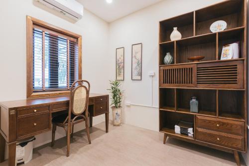 an office with a desk and a book shelf at Lily Hidden Homestay in Hanoi