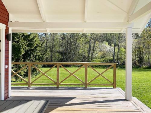 a screened porch with a wooden fence at 4 star holiday home in LJUSTERÖ in Norra Ljustero