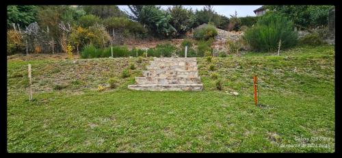 a stone wall in the middle of a field at Ocho Cabañas in San Carlos de Bariloche