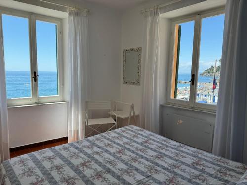 a bedroom with a bed and a view of the ocean at Sori Mare in Sori
