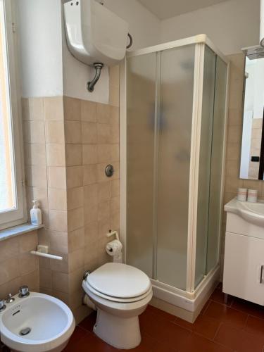 a bathroom with a shower and a toilet and a sink at Sori Mare in Sori