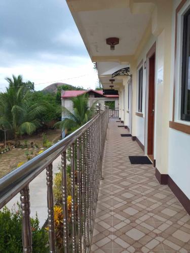 a balcony of a building with a view of the ocean at golden anchor lodge in Coron