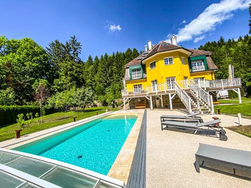 a house with a swimming pool in front of a house at Luxusvilla Österreich in Scheibbs