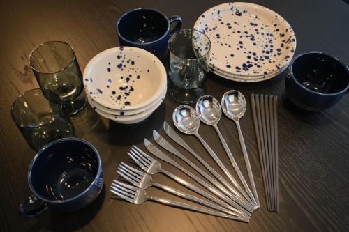a table with plates and spoons and forks and glasses at Blighton Miyoshi by Tranova in Tokyo
