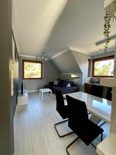 a living room with a white table and chairs at Apartamenty-Baltivia in Hel