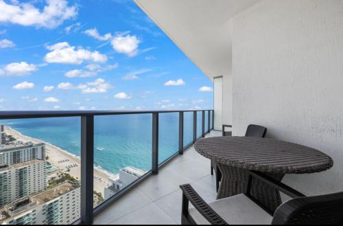 a balcony with a table and a view of the ocean at Lyfe Oceanview Resort Luxury 2 Bedroom Unit in Hollywood