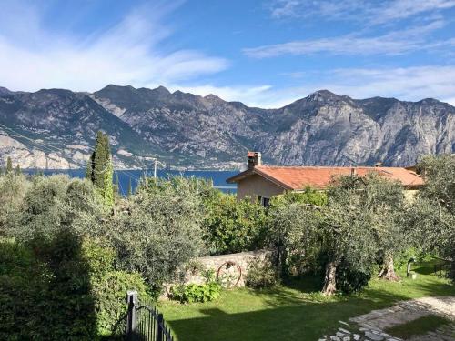 a house with a view of the mountains at Relais PINF in Malcesine