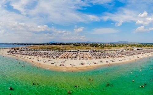 a beach with a large crowd of people in the water at Chris & Mary Comfort Rooms (country house) in Nea Iraklia
