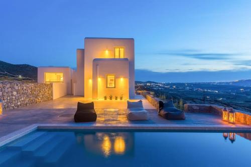 a villa with a swimming pool at night at Cabana Seaview Pool Villas w Night Security Guard, near Alemagou beach in Elia