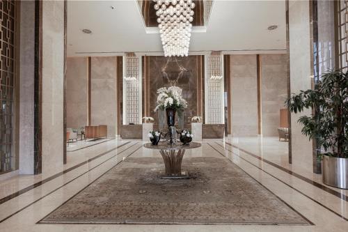 a lobby with a vase of flowers on a table at Concorde Tower Hotel & Casino in North Nicosia