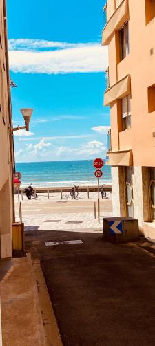 a view of the beach from a street near a building at Studio Remblai LS in Les Sables-d'Olonne