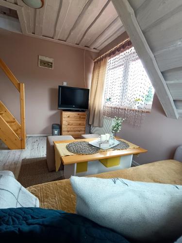 a living room with a table and a couch at Rodzinny zakątek "U Głuszków" Bieszczady in Myczkowce