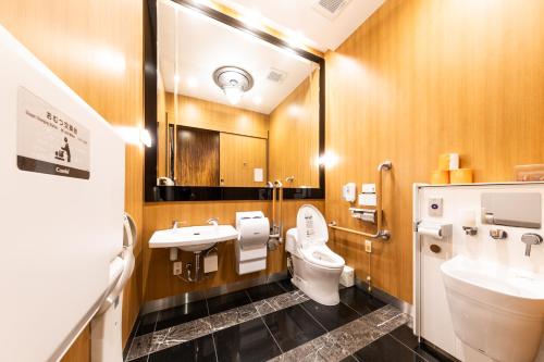 a bathroom with a toilet and a sink at APA Hotel Yodoyabashi Kitahama Ekimae in Osaka