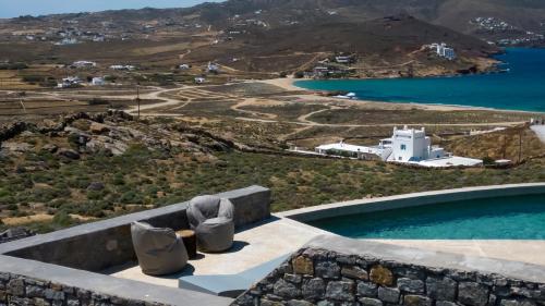 a pool with two chairs sitting on top of a building at Cabana Seaview Pool Villas w Night Security Guard, near Alemagou beach in Elia