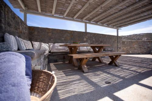 a patio with a couch and a wooden table at Cabana Seaview Pool Villas w Night Security Guard, near Alemagou beach in Elia