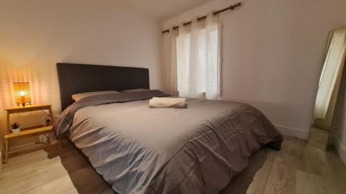 ein Schlafzimmer mit einem großen Bett in einem Zimmer in der Unterkunft Appartement cool en plein centre de Libourne in Libourne