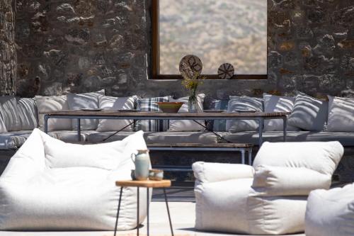 a room with white couches and a table with pillows at Cabana Seaview Pool Villas w Night Security Guard, near Alemagou beach in Elia