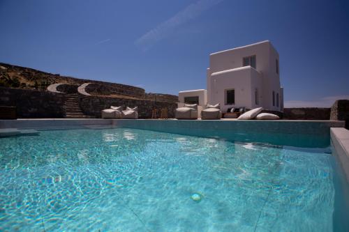 a swimming pool in front of a villa at Cabana Seaview Pool Villas w Night Security Guard, near Alemagou beach in Elia