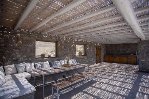 a room with a couch and a table in it at Cabana Seaview Pool Villas w Night Security Guard, near Alemagou beach in Elia