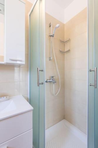 a bathroom with a shower and a sink at Studio Ruzmarin in Krk