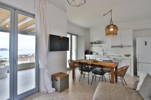 a kitchen and dining room with a table and chairs at Cabana Seaview Pool Villas w Night Security Guard, near Alemagou beach in Elia