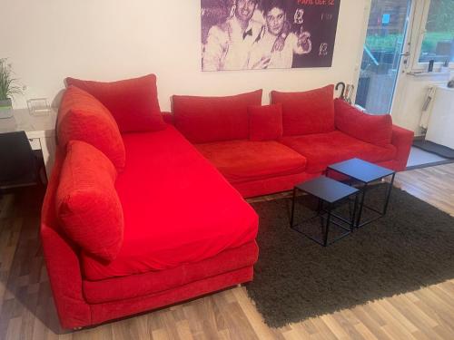 a red couch sitting in a living room at gemütliches Einliegerapartment, 50 qm in Trippstadt