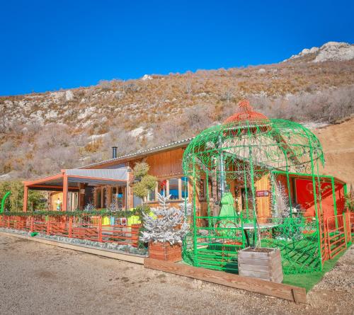 a building with a green bird cage in front of it at La Bella Vista in Curel