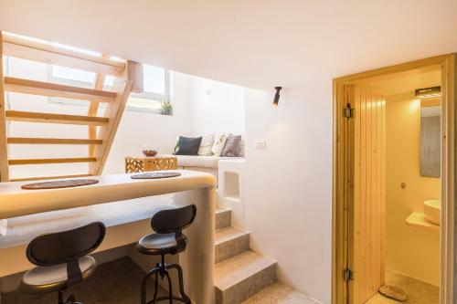 a room with a desk and two chairs and a bed at Cabana Seaview Pool Villas w Night Security Guard, near Alemagou beach in Elia