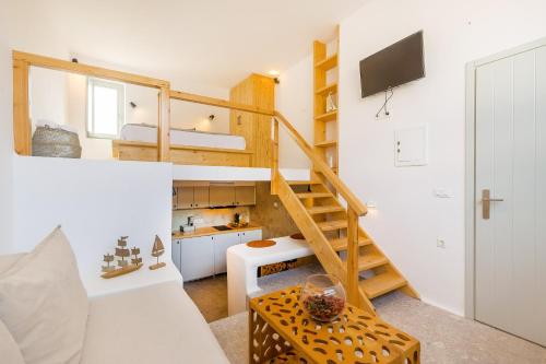 a tiny house with a staircase and a kitchen at Cabana Seaview Pool Villas w Night Security Guard, near Alemagou beach in Elia