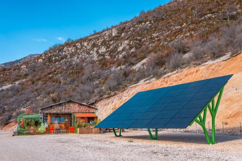 a large blue solar panel in front of a mountain at La Bella Vista in Curel