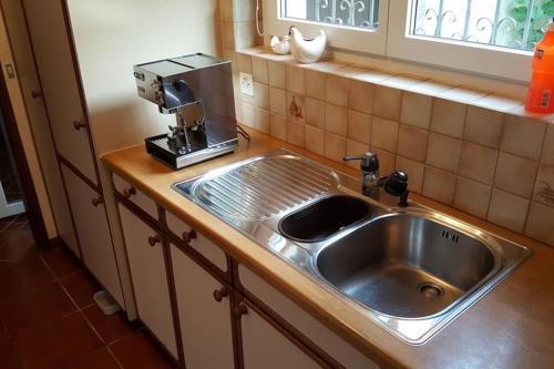 a kitchen sink with a coffee maker on top of it at Casa Dolores in Lugano