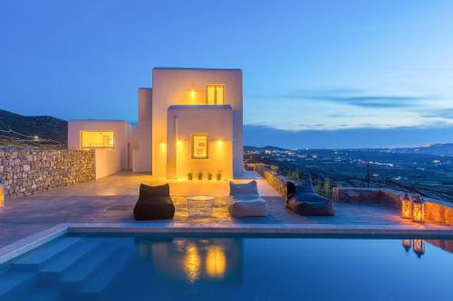 a villa with a swimming pool at night at Cabana Seaview Pool Villas w Night Security Guard, near Alemagou beach in Elia