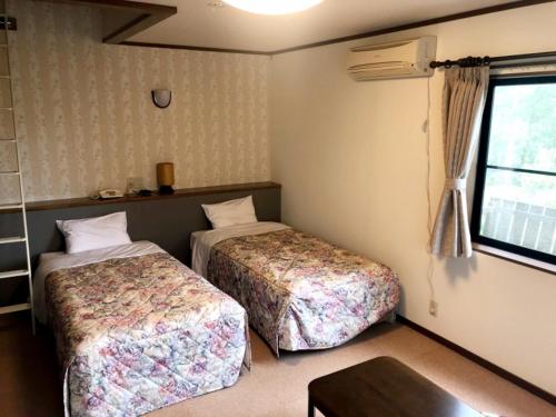 Ένα ή περισσότερα κρεβάτια σε δωμάτιο στο Ikenoya