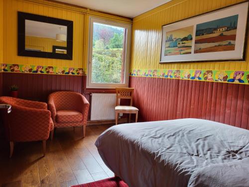 a bedroom with a bed and a chair and a window at Le reposoir in Mont-Saxonnex